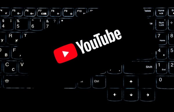 YouTube logo displayed on a backlit keyboard, representing digital media and online content creation.