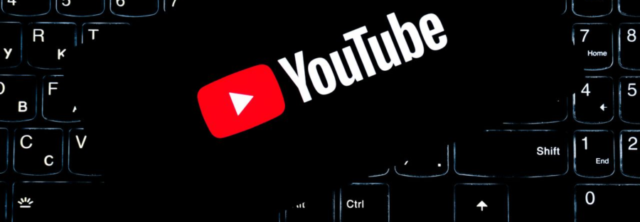 YouTube logo displayed on a backlit keyboard, representing digital media and online content creation.